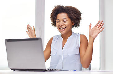 Image showing happy african woman with laptop at office