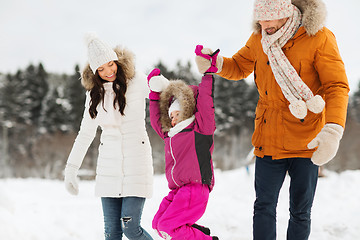 Image showing happy family in winter clothes walking outdoors