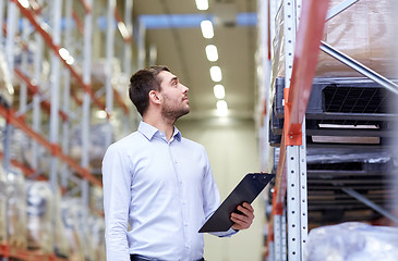 Image showing happy businessman with clipboard at warehouse