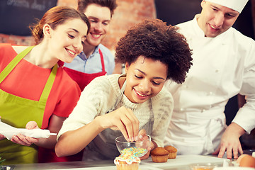 Image showing happy friends and chef cook baking in kitchen