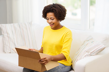 Image showing happy african young woman with parcel box at home