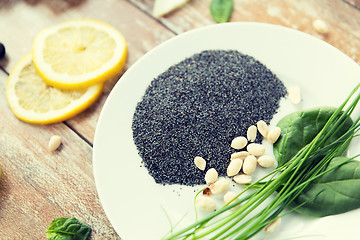 Image showing close up of peeled peanuts, greens and chia seeds