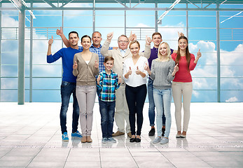 Image showing group of smiling people showing thumbs up