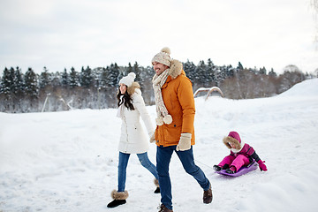 Image showing happy family with sled walking in winter outdoors