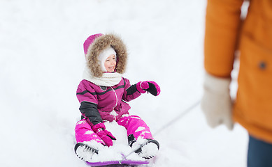 Image showing happy little kid on sled outdoors in winter