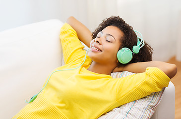 Image showing happy woman with headphones listening to music