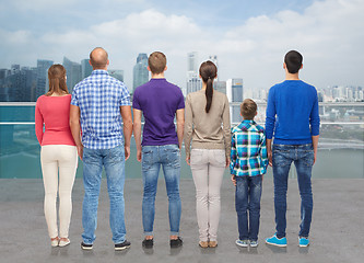 Image showing group of people from back over city waterside