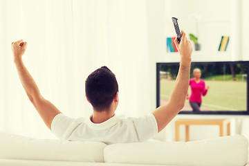 Image showing man watching sport channel on tv and at home