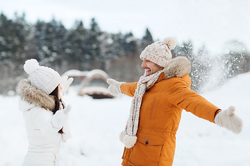 Image showing happy couple playing with snow in winter