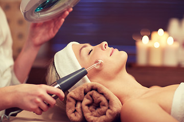 Image showing close up of young woman having face massage in spa