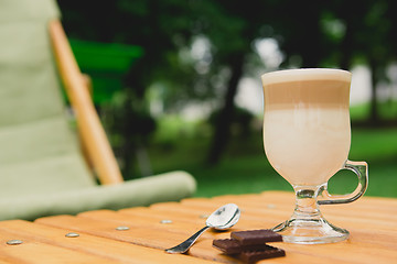 Image showing Morning coffee. Cup coffee in park