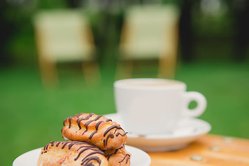 Image showing Morning coffee. Cup coffee in park