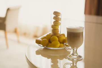 Image showing Cup coffee in hotel with macaroons