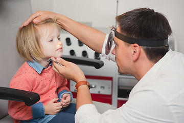 Image showing Doctor ENT checking ear with otoscope to girl patient 