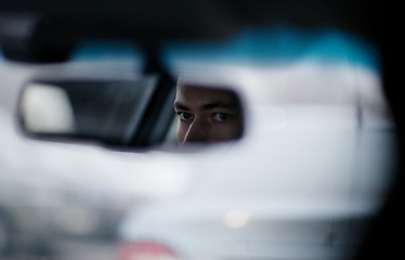 Image showing Man looking in the rear view mirror while driving