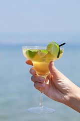 Image showing Womans hand holding a glass of cocktail