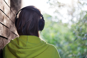 Image showing Woman listening to music outdoor