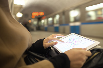 Image showing Tablet in female hands showing subway map in underground