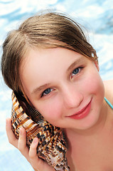 Image showing Young girl with seashell