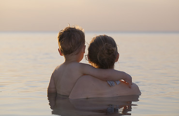 Image showing Mother and son watching the sunset