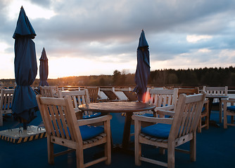 Image showing Tables in outdoor bar on stern of cruise liner