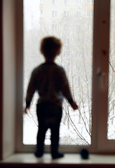 Image showing Boy is looking through the window.