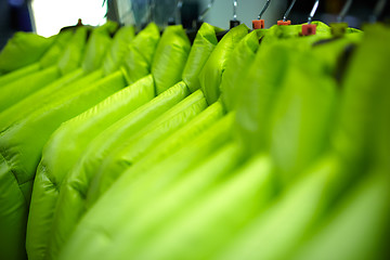 Image showing Sport and casual clothes on hangers in the shop.