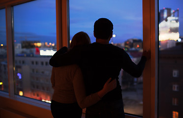 Image showing Couple embracing and looking at evening city together