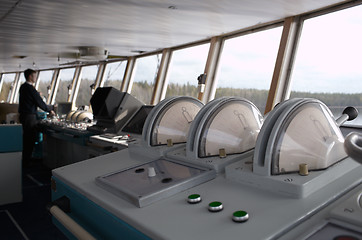 Image showing Navigational officer driving ship on the river.