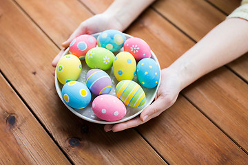 Image showing close up of woman hands with colored easter eggs