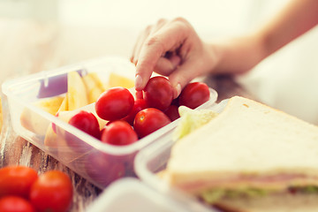 Image showing close up of woman with food in plastic container