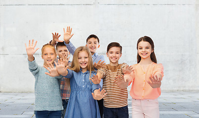 Image showing happy children waving hands