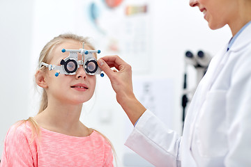 Image showing optician with trial frame and girl at clinic