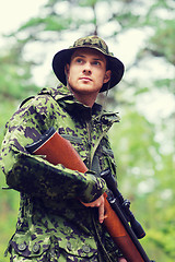 Image showing young soldier or hunter with gun in forest