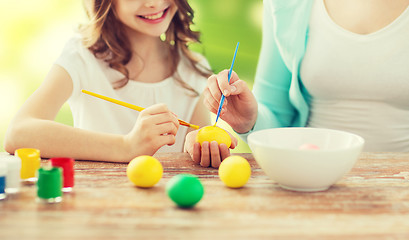 Image showing close up of family coloring easter eggs