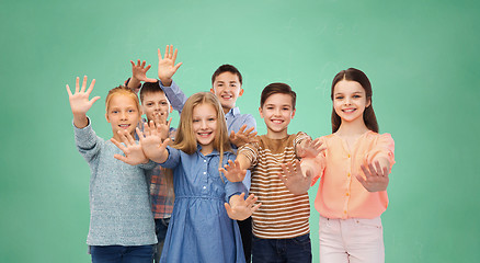 Image showing happy children waving hands