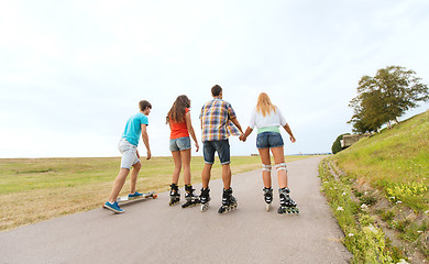 Image showing teenagers with rollerblades and longboards