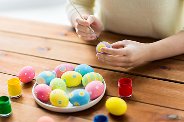 Image showing close up of woman hands coloring easter eggs