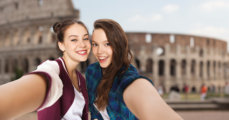 Image showing happy teenage girls taking selfie over coliseum