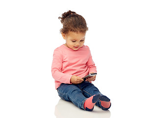 Image showing smiling little baby girl playing with smartphone