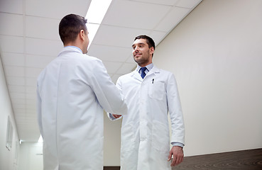 Image showing smiling doctors at hospital doing handshake