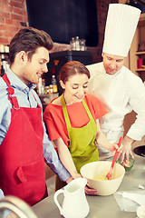 Image showing happy couple and male chef cook cooking in kitchen