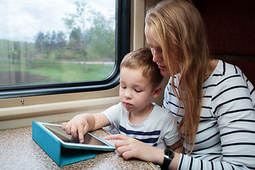 Image showing Son and his mom with tablet PC in the train