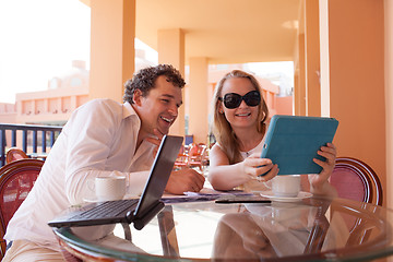 Image showing Young couple relaxing over coffee on a balcony