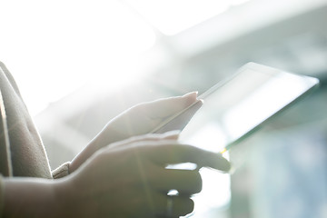 Image showing Woman using tablet PC against bright sunlight