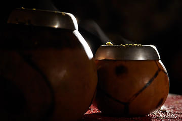 Image showing Two yerba mate calabashes with smoke.