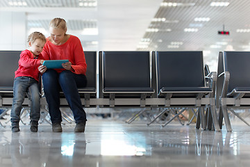 Image showing Young mother and son in an airport terminal