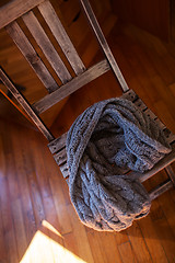 Image showing Woollen scarf lying on wooden chair