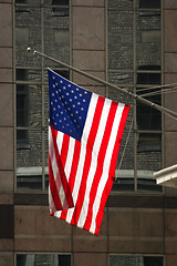 Image showing American flag hanging on building