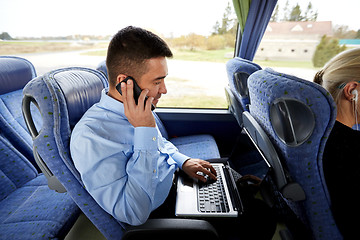 Image showing man with smartphone and laptop in travel bus